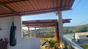 a balcony of a house with a view of a river at Temporada Monte gordo in Camacari