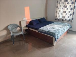 a small bedroom with a bed and a chair at Fortune Heritage Resort in Baori Thikria +3 photos