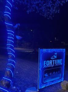 a sign sitting next to a tree at night at Fortune Heritage Resort in Baori Thikria