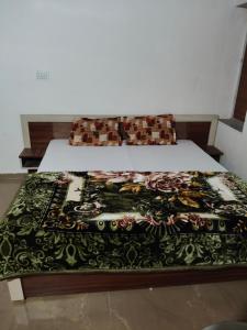 a bed with a black and white blanket on it at Fortune Heritage Resort in Baori Thikria