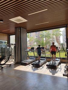 two people riding on treadmills in a gym at Serenity Residence in Alanya