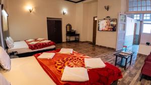 a hotel room with two beds with towels on them at Hotel Dalziel in Shimla