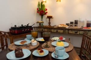 a table with plates of food on top of it at Pousada da Villa in Fernando de Noronha +13 photos