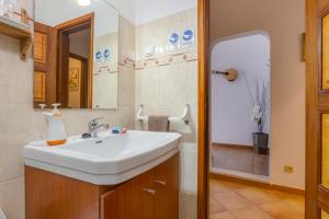 a bathroom with a white sink and a shower at Casa Flor do Mar Lagos in Lagos +48 photos