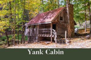 an old cabin in the woods with the words yank cabin at Moore House Inn & Cabins in Marlinton