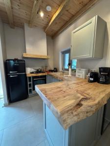 a kitchen with a wooden counter top in a room at Cedar Wood Cabin in Áno Polídhrosos