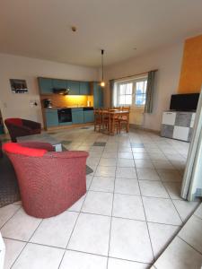 a living room and kitchen with a table and chairs at BERNSTEINHAUS in Zingst barrierefreie 2-Raum-Wohnung mit Terrasse - Nr 1 in Zingst +11 photos