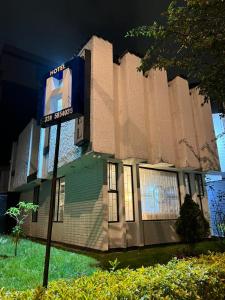 a building with a sign in front of it at Casa Hotel Estancia Bogota in Bogotá