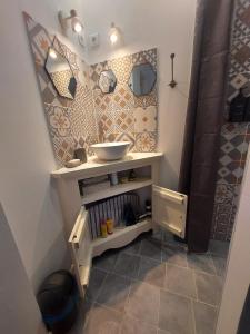 a bathroom with a sink and a bowl on a shelf at Chez Agatha in Vertheuil-en-Médoc +42 photos