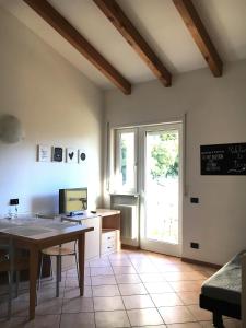 a kitchen with a table and a desk and a window at Trento Life in Trento