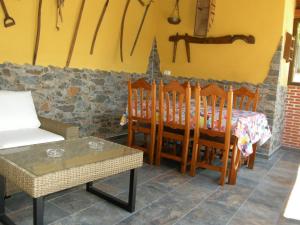 a dining room with a table and some chairs and a table and a tablektop at Casa rural El Laurel in Chañe +32 photos