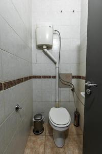 a small bathroom with a toilet and a sink at National Stadium 1BR by BulgarianHomes in Sofia +14 photos
