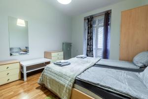 a bedroom with a large bed and a mirror at National Stadium 1BR by BulgarianHomes in Sofia