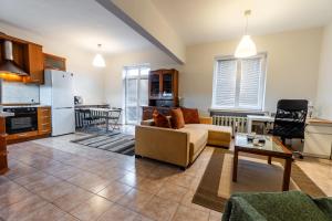 a living room with a couch and a table at National Stadium 1BR by BulgarianHomes in Sofia