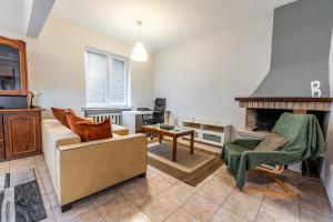 a living room with a couch and a fireplace at National Stadium 1BR by BulgarianHomes in Sofia