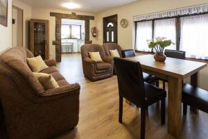 a living room with a table and chairs at Apartamentos Carolina in Celorio