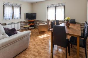 a living room with a couch and a table at Apartamentos Carolina in Celorio