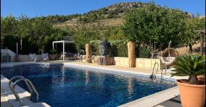 a swimming pool in a house with a mountain in the background at B&B Boutique Casa Clavi in Chirivel