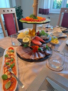 a table with a plate of food on a table at Privatzimmer Helga Haselberger in Ybbs an der Donau