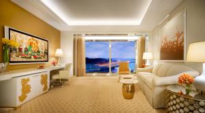 a living room with a couch and a large window at Wynn Palace in Macau