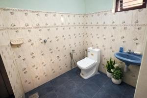 a bathroom with a toilet and a sink at Golden Breeze Bekal in Bedadka