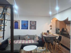 a living room with a couch and a table at Lille Flandre duplex in Lille