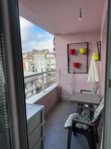 a balcony with a desk and a table and a window at Apartman Harmony in Ohrid