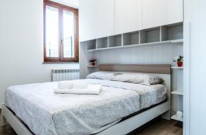 a bedroom with a large bed with white sheets at Tabor Garden near Lake Maggiore by Kibilù Affitti Brevi in Golasecca
