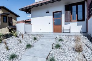 a house with a pathway leading to the front door at Tabor Garden near Lake Maggiore by Kibilù Affitti Brevi in Golasecca