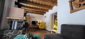 a living room with a couch and a fireplace at Chata Krpko in Horná Lehota