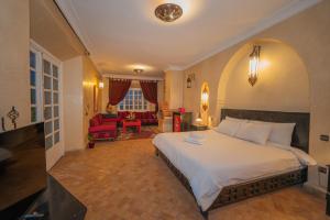 a bedroom with a large bed and a living room at Mumtaz Dar in Marrakesh