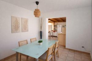 a dining room with a blue table and chairs at The Tree House Coliving in El Médano