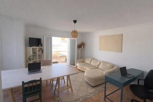 a living room with a table and a couch at The Tree House Coliving in El Médano