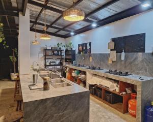 a kitchen with two sinks and a counter top at Basilia Guest House in Bantayan Island +40 photos