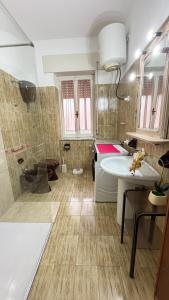 a bathroom with a shower and a sink and a tub at Budoni Casa Vacanze - MAR DEI CORALLI in Budoni +22 photos