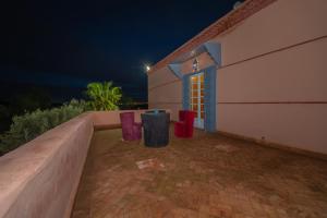 a building with two trash cans in front of it at night at Mumtaz Dar in Marrakesh