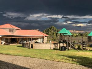 a playground in front of a house with a dark sky at Riverside Inn in Oranjeville