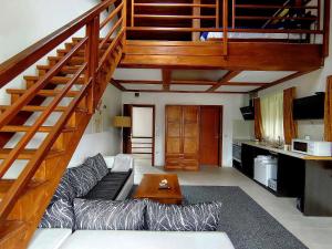 a living room with a couch and a wooden staircase at Homely in Bansko
