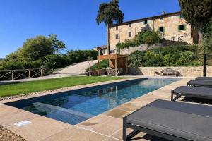 a swimming pool in front of a building at Villa Gianotti by MMega in Lugnano
