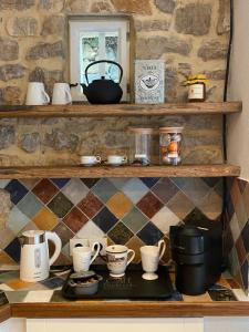 a shelf with cups and other items on it at Le Mas Sainte Thérèse in Grasse +27 photos