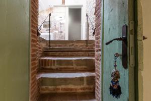 an open door to a stairway with brick stairs at Villa Gianotti by MMega in Lugnano