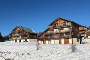 a large building in the snow in front at T2 cosy 4 pers balcon vue montagne la Joue du loup in Le Dévoluy