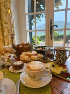 a table with a cup of coffee and a plate of food at La Bastide Sainte Thérèse in Grasse