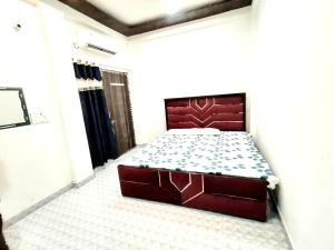 a bedroom with a large bed in a room at Banaras Apartment Homestay 7BHK AC & NON AC ROOMS in KASHI VISHWANATH JYOTIRLING in Varanasi