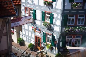 a tall building with lots of windows and flower boxes at Berne's Altstadthotel in Besigheim