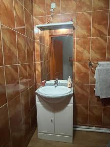 a bathroom with a sink and a mirror at Royal Haveli in Tergnier