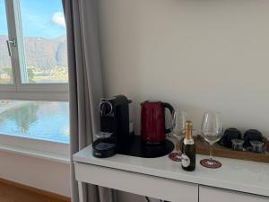 a room with a table with wine bottles and glasses at Lac Hotel in Melide