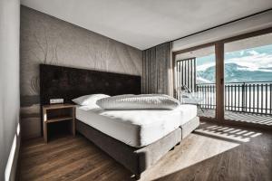 a bedroom with a bed and a balcony at Residence Froy in Resia