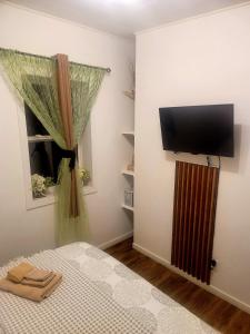 a bedroom with a bed and a flat screen tv at Warm cozy 1 bdrm close to Hwy in Edmundston