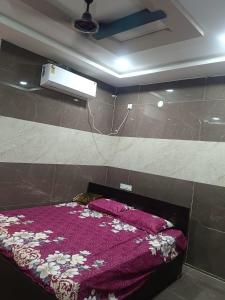 a bedroom with a bed with a purple blanket at Ram Hari Hara Convention in Khammam